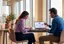 Two colleagues in a subject matter expert interview, one asking questions and taking notes while the other explains a process on screen