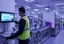 Operator following a visual SOP for manufacturing on a tablet next to a production line workstation