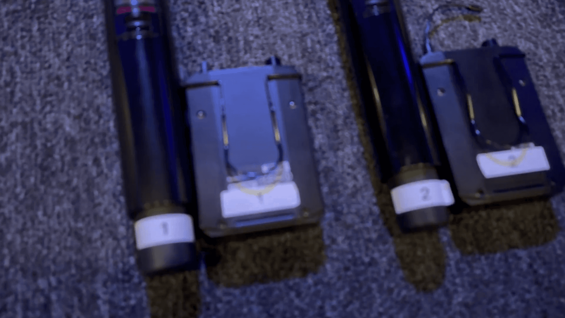 Step #7: Arrange the microphones and packs on the center platform, making them available for use.For each microphone labeled 1 through 9, match it with its corresponding numbered pack.