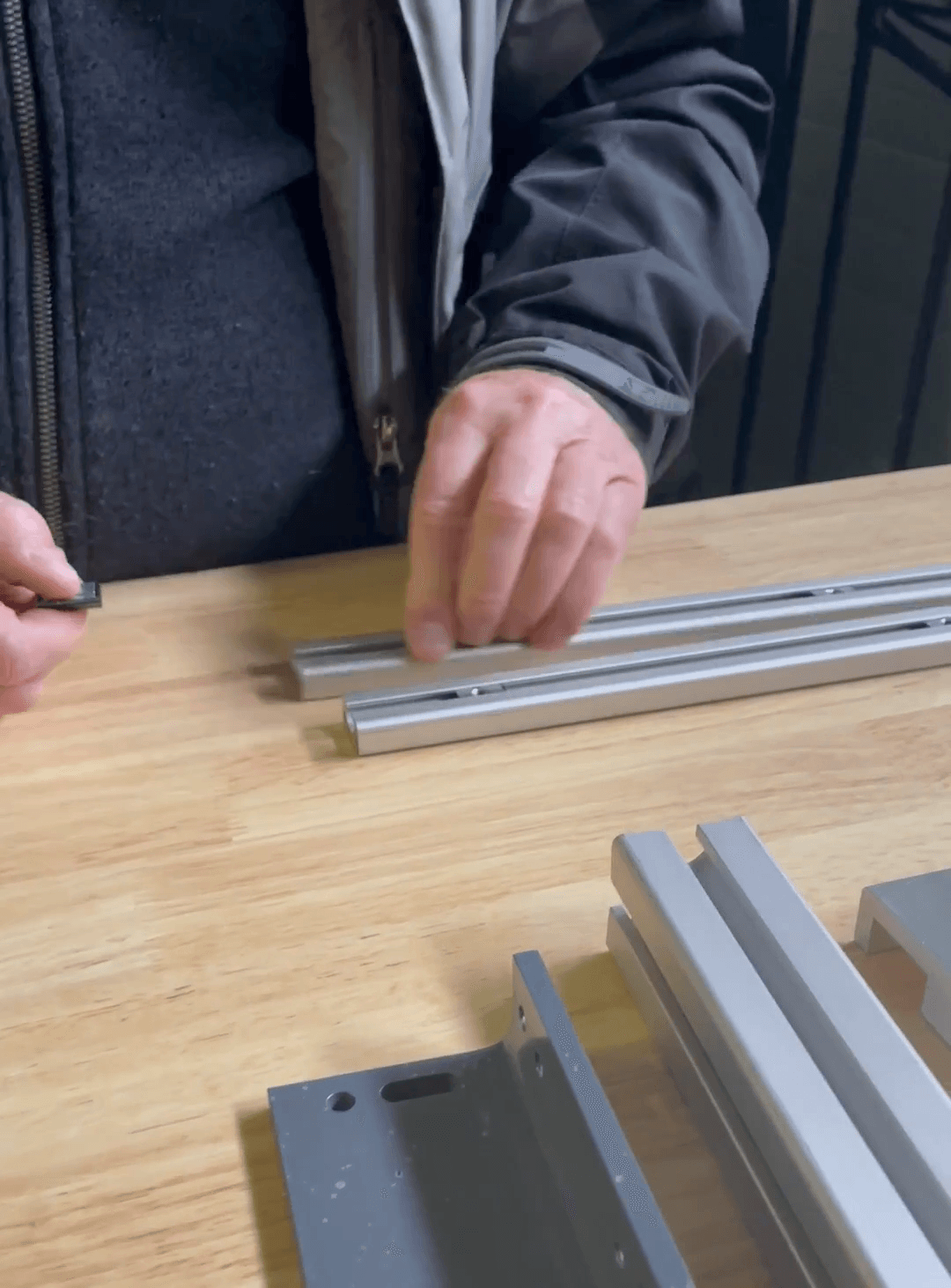 Step #3: Insert the larger T-nuts into the larger series 15 T-slotted rail. Insert three of the T-nut assemblies into the track of one of the rails. Repeat the process for the second rail.