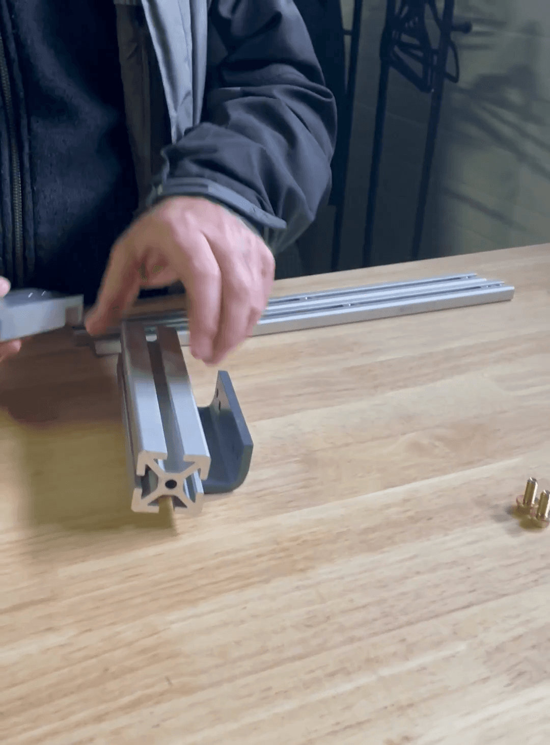Step #5: Mount aluminum rail bracket to the larger rail.Slide the small rails into place and fasten them. Place the aluminum rail bracket on top of the larger rail.