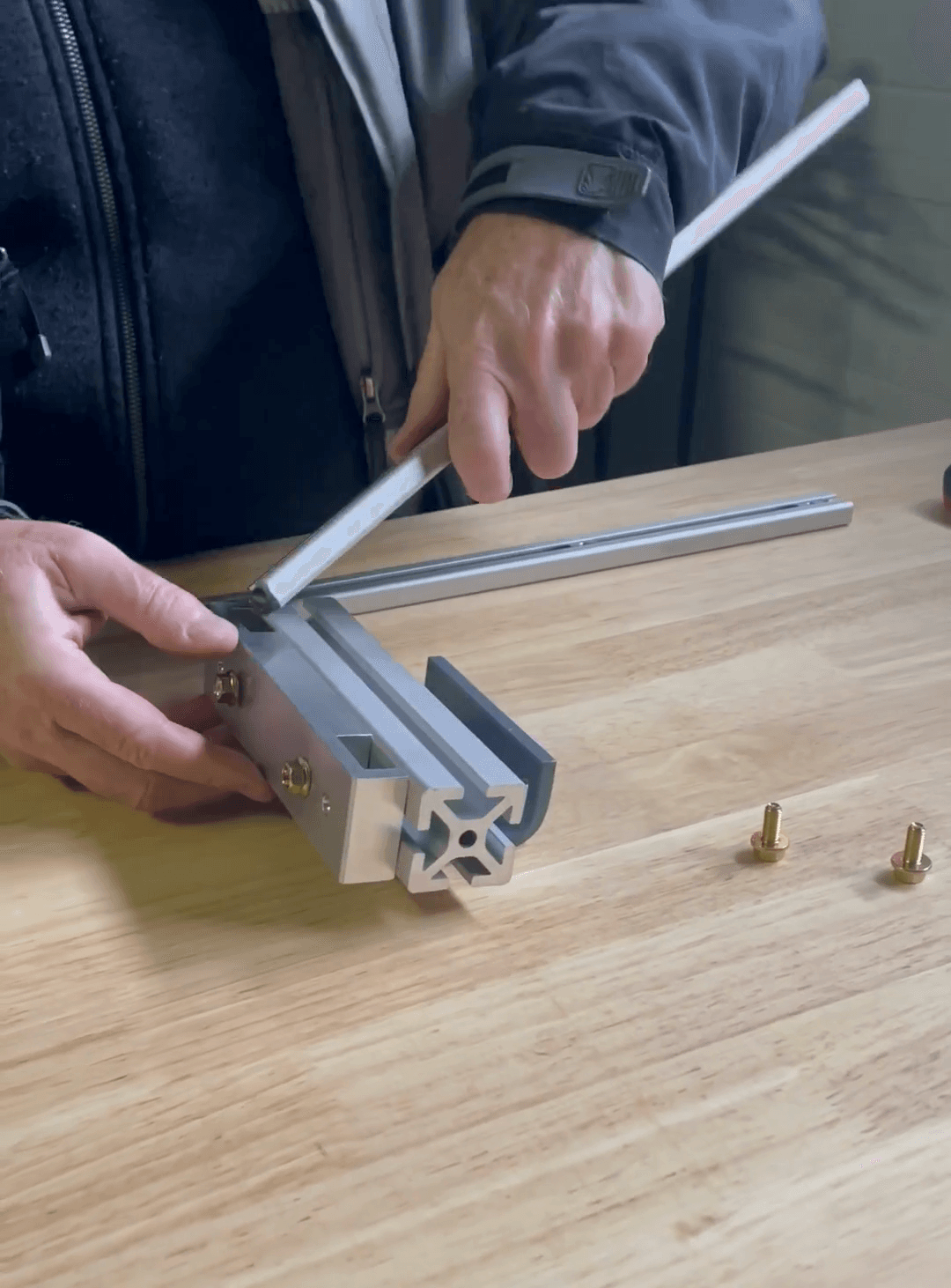 Step #7: slide the small rails into place and fasten.Slide the first small rail into the groove of the main assembly.Tighten all the hardware with a 10-millimeter wrench.