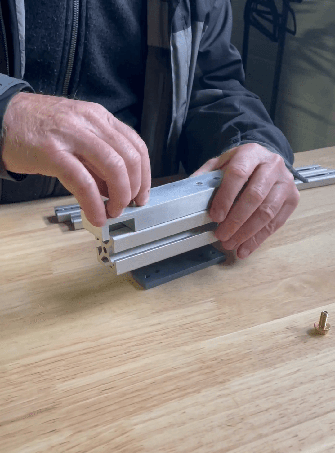 Step #6: Insert the first screw into the rail bracket.Hand-tighten the first screw.Insert and hand-tighten the second screw into the rail bracket.
